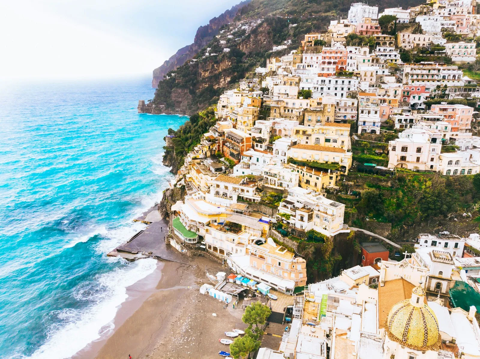 Sunlit cliffside village above a deep blue sea on the Amalfi Coast