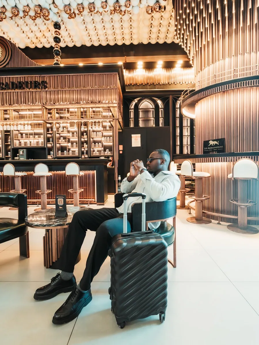 A well-dressed traveler waiting in an elegant hotel lounge