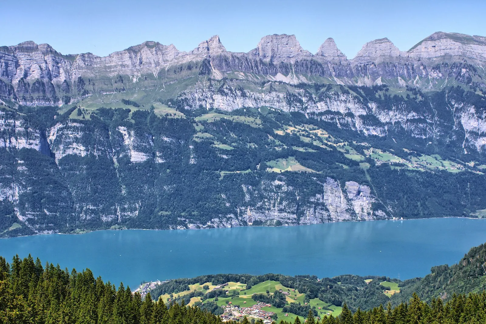 Snow-capped mountains towering over a serene alpine lake